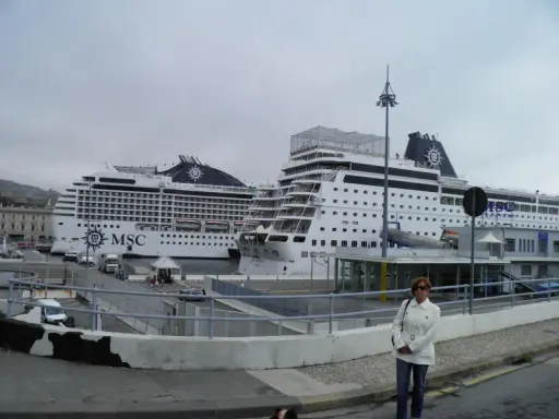 Donna in piedi davanti a due navi MSC in attesa dell'imbarco a Genova per Portofino.