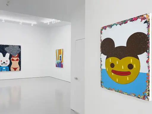 A gallery showcases vibrant paintings by Eli Klein. One features a cartoon rabbit and bikini-clad torso with smoke, another a colorful abstract, and a large piece with a yellow, Mickey Mouse-like face.