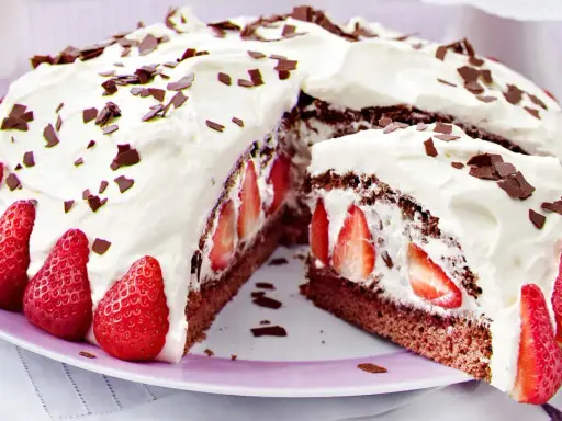 Saftige Stracciatella Torte mit frischen Erdbeeren und Schokostückchen, üppig mit Sahne verziert.