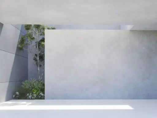 Moderne Architektur mit transluzentem Beton und grüner Vegetation. Sonnenlicht fällt durch eine Öffnung und beleuchtet den Boden.