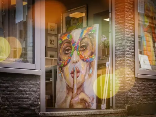 A vibrant painting of a woman in a colorful mask hints why rich people buy art: for beauty, status, and a touch of mystery.