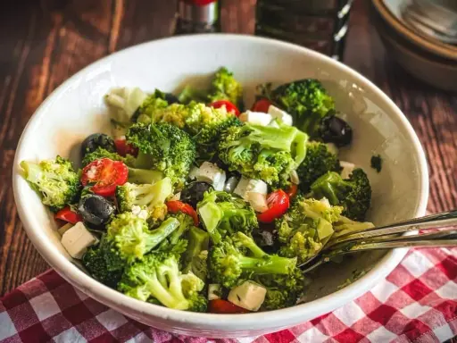 Frischer Brokkolisalat mit Kirschtomaten, schwarzen Oliven und Feta. Perfekt für gesunde Brokkoli Rezepte.