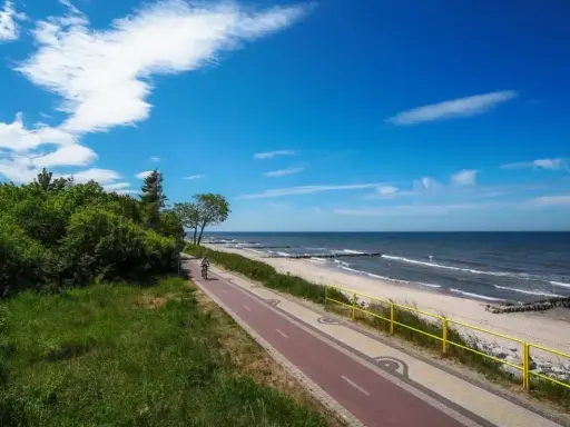 Piękny dzień nad polskim morzem. Ścieżka rowerowa wzdłuż plaży, idealna na wakacje.