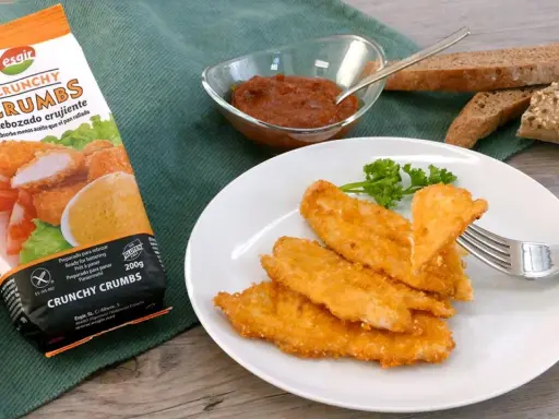 Escalope de pollo crujiente, listo para disfrutar. Acompañado de pan y salsa.