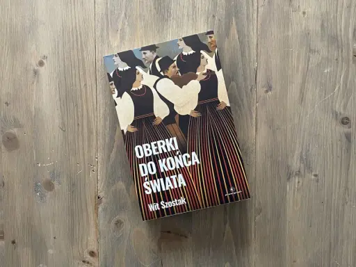 Okładka książki "Oberki do końca świata" Wita Szostaka, z ludowym motywem postaci w tradycyjnych strojach.