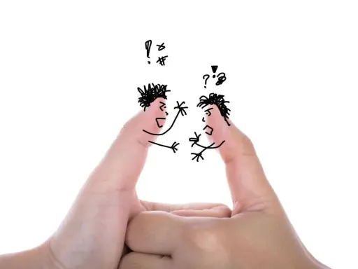 Due dita disegnate come volti litigiosi, un'analogia visiva per un dibattito acceso.