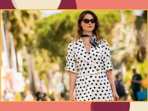A woman in a stylish polka dot outfit, perfect for inspiration on what to wear to a beach wedding.