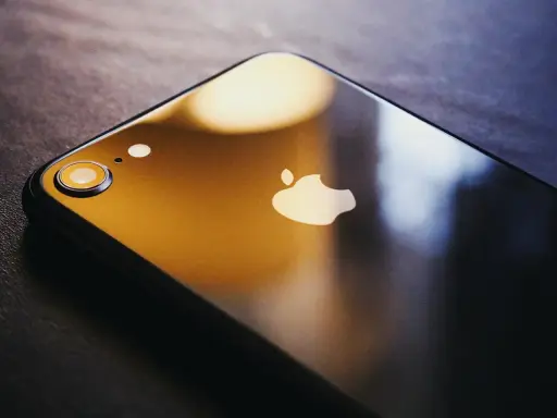 Ciemny iPhone z logo Apple. Dowiedz się, jak zmienić Apple ID, aby zabezpieczyć swoje dane.