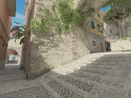 Kamienna ścieżka i schody w klimacie tuscan cs go, z widokiem na latarnię morską i budynki.
