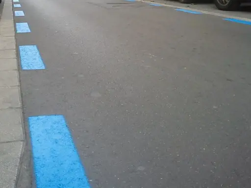 Marcas azules en el asfalto indican zona de aparcamiento regulado. Si no pagaste, así podrías saber si te han multado en zona azul.