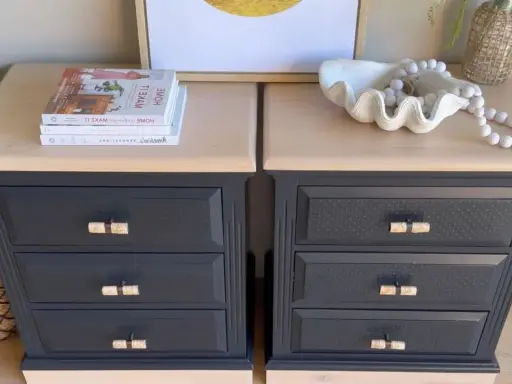 Deux tables de chevet relookées. Le bois foncé a été peint en gris anthracite, avec des poignées en rotin. Un projet réussi pour relooker un meuble en bois foncé.