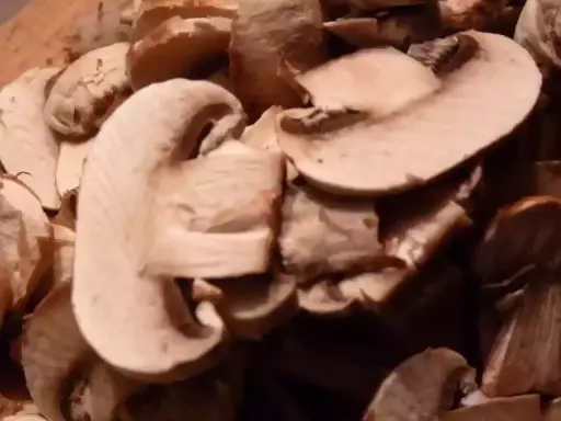 Champignons coupés en lamelles, prêts pour une recette de champignons à la grecque.