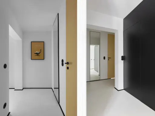 Minimalistyczny, mały przedpokój inspiracje ściany: złote i czarne drzwi, lustro, grafika z fotelem Eamesa.