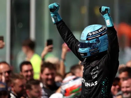 Jubel nach der F1 Qualifying Kanada. Fahrer mit blauem Helm und Handschuhen feiert mit erhobenen Fäusten.
