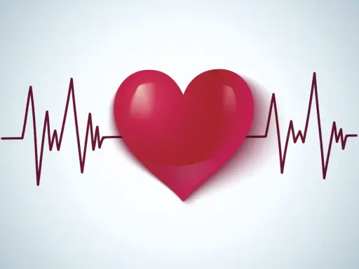 Czerwone serce na tle wykresu EKG. Symbolizuje zdrowie, życie i walkę z wadami serca, takimi jak np. VSD.