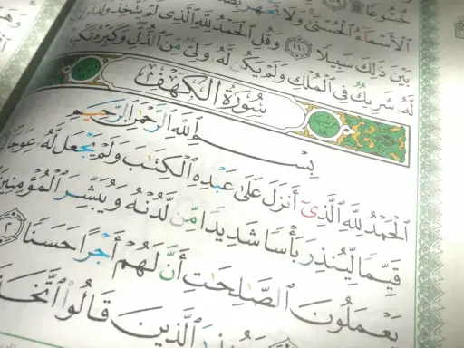 Sure, hier ist der Alt-Text auf Deutsch:

Sure Kahf, die letzten 10 Verse, mit arabischer Kalligraphie auf Papier.