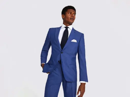 A man in a sharp blue suit, white shirt, and dark tie. This image helps answer how much should a suit cost.