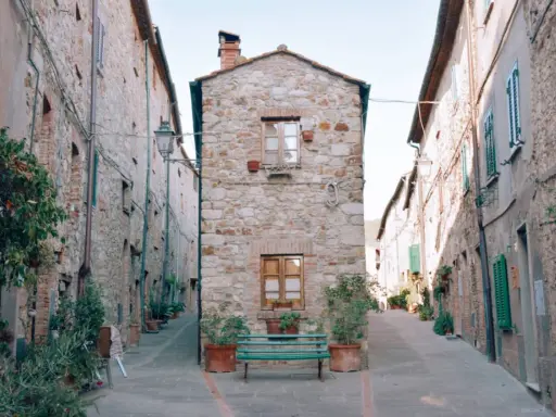 Un vicolo stretto con case in pietra e piante in vaso. Un invito a scoprire cosa vedere a Cecina, tra scorci pittoreschi e storia.
