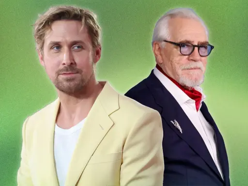 Two men in colorful cocktail attire. Ryan Gosling in a pale yellow suit, Brian Cox in a navy suit with a red ascot.