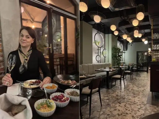 Kobieta z kieliszkiem wina w jednej z klimatycznych restauracji na krakowskim Starym Mieście. Wnętrze lokalu z nowoczesnym designem.