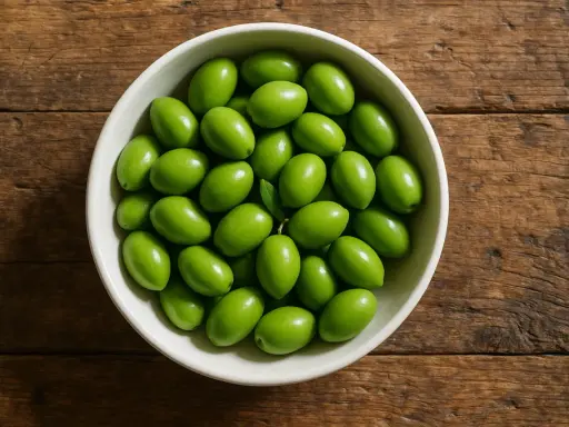 Un cuenco lleno de olivas verdes frescas, perfectas para disfrutar de sus beneficios.