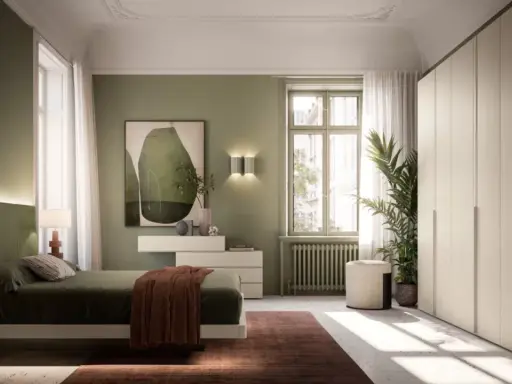 Camera da letto con accogliente **parete verde salvia**. Letto comodo, armadio capiente e un quadro astratto completano l'ambiente.
