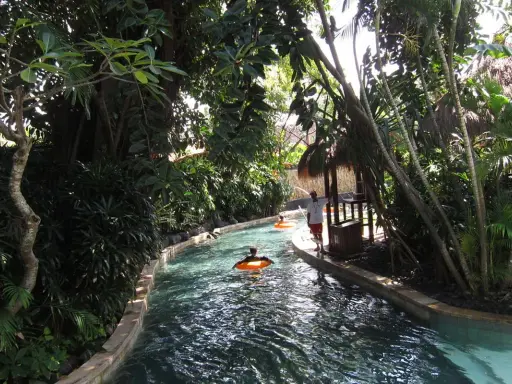 Un día perfecto para viajar a Bali con niños, disfrutando de un río tranquilo rodeado de exuberante vegetación tropical.
