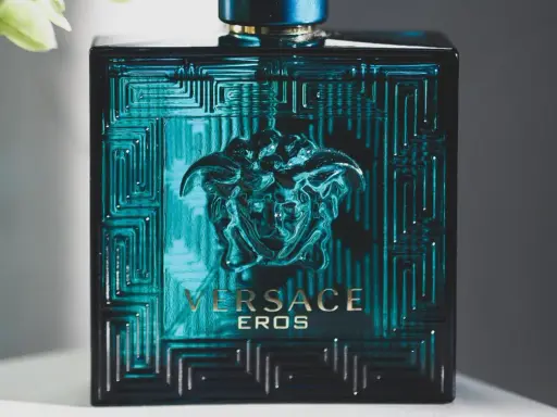 Butelka perfum męskich Versace Eros w turkusowym kolorze z greckim wzorem i głową Meduzy.