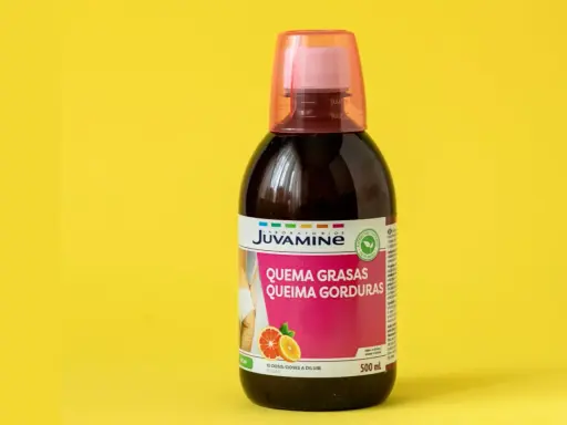 Botella de líquido quemagrasas con etiqueta rosa y naranja sobre fondo amarillo.