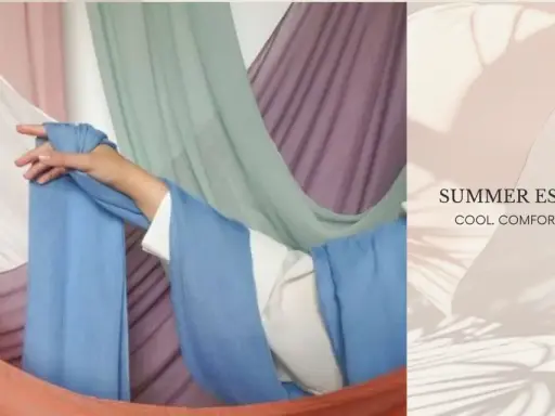A hand drapes light blue fabric, suggesting the best clothing material for summer is breathable and cool.