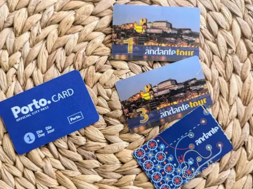 Porto.CARD und Andante Tour-Karten liegen auf einem geflochtenen Untergrund. Perfekt für eine Entdeckungsreise in Porto.