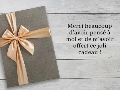 Un cadeau gris avec un ruban doré, accompagné d'un message : "Merci beaucoup d'avoir pensé à moi et de m'avoir offert ce joli cadeau !
