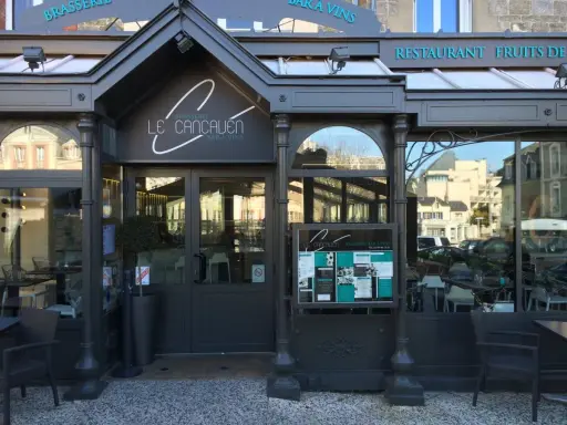 La façade de la meilleure brasserie Saint-Malo, "Le Cancaluen", avec son enseigne élégante et ses grandes vitrines reflétant la ville.