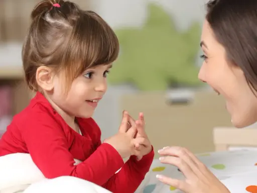 Ein kleines Mädchen und eine Frau sprechen liebevoll miteinander. Dies zeigt, welche erziehungsstile es gibt, wie z.B. den autoritativen Stil.