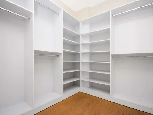 Ideas para vestidor cerrado: estanterías blancas y barras para colgar ropa, creando un espacio organizado y funcional.