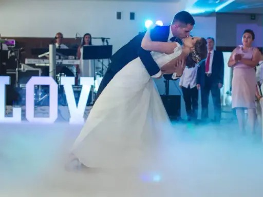 Para młoda tańczy do muzyki na weselu, otoczona mgłą i literami "LOVE". To jak scena z najsłynniejszych baletów.