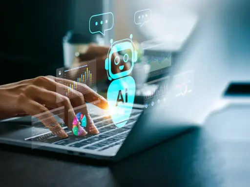 Ręce na klawiaturze laptopa, nad nią świecący bot AI i wykresy. To przyszłość ai marketing.