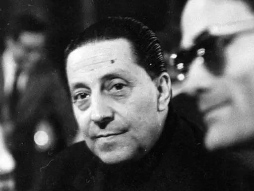 Ritratto in bianco e nero di Sandro Penna, poeta, con uno sguardo intenso. Le sue poesie sono un tesoro della letteratura italiana.