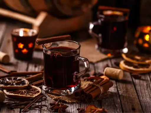 Ciepłe, jesienne drinki z cynamonem i anyżem, ozdobione suszonymi pomarańczami, tworzą przytulną atmosferę.