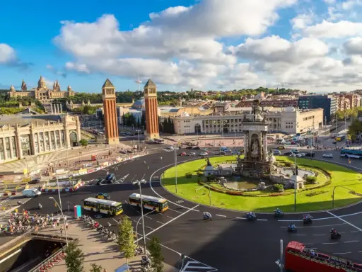 Widok na plac z fontanną i wieżami, idealny na weekend w Barcelona.