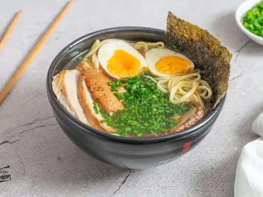 Un delicioso tazón de ramen con fideos, huevo cocido, carne de cerdo, cebollín y alga nori. Una tentadora receta ramen lista para disfrutar.