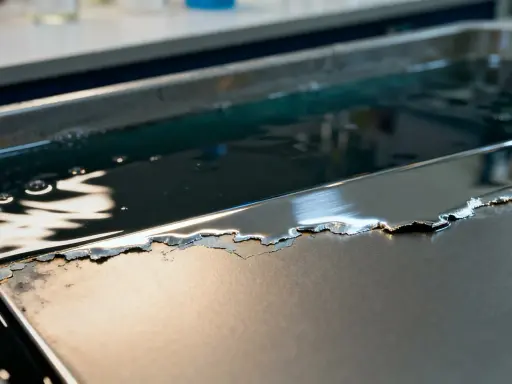Metalowa powierzchnia z odpryskującym chromem, zanurzona w płynie. Zastanawiasz się, czym wyczyścić chrom?