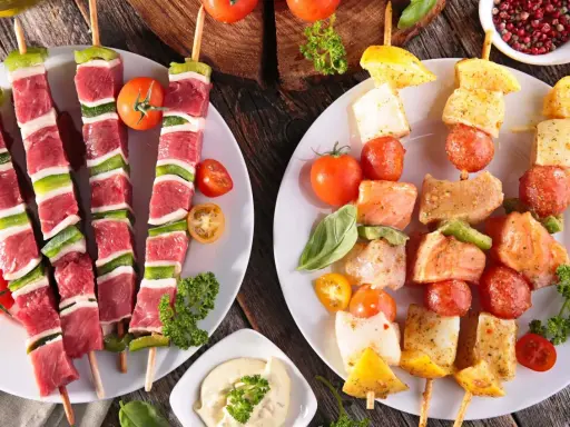 Fleisch- und Fischspieße mit Gemüse und Dip – perfekt, wenn man fragt, was man zum Grillen mitbringt.