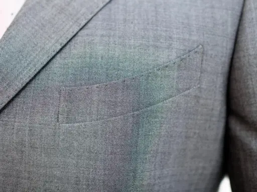 A suit jacket's breast pocket is sewn shut. This is often done to maintain the jacket's crisp silhouette, as why are pockets sewn shut is a common question for new suit owners.