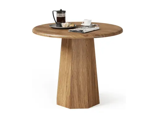 Ett runt, träfärgat litet slagbord med en kaffepress, en kopp och en tidning.