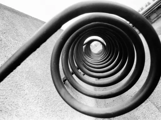 A spiral staircase, reminiscent of Edward Weston's famous photos, draws the eye inward.