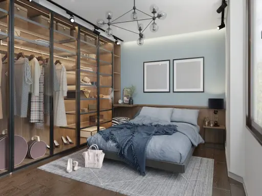 Chambre moderne avec dressing vitré bien organisé, lit bleu douillet et deux cadres vides au mur.