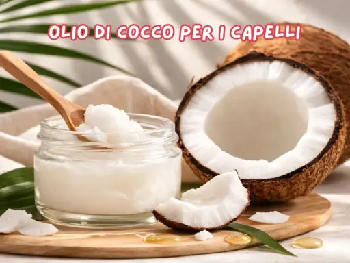 Olio di cocco per capelli: scopri le sue incredibili proprietà. Un vasetto di olio di cocco, un cocco aperto e foglie verdi.
