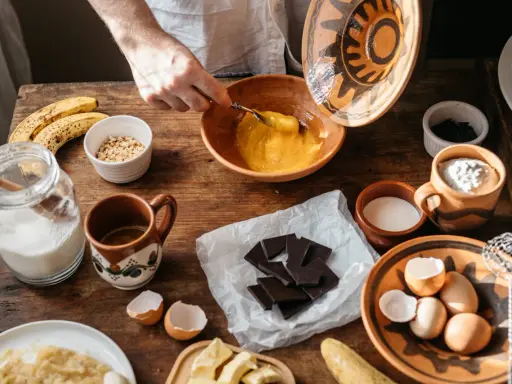 Préparation d'une recette avec des ingrédients comme des œufs, des bananes et du chocolat qui ne fond pas.