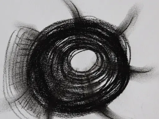 Abstract charcoal mark making examples, featuring a dark, spiraling circle with radiating lines on a white background.